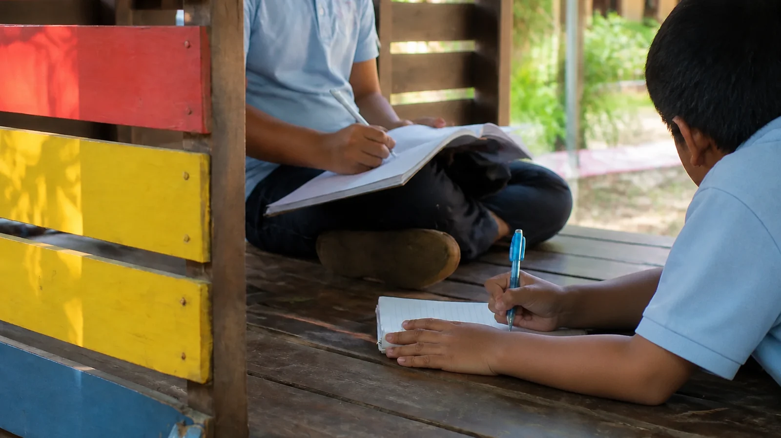 Two Saint George students studying together in a calm outdoor setting without identifiable faces